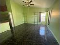 Spacious living room with dark tile floors and a ceiling fan at 2226 Ridgemore Dr, Valrico, FL 33594