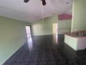 Open living room and kitchen area with dark tile floors at 2226 Ridgemore Dr, Valrico, FL 33594