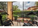 Relaxing screened porch with outdoor furniture, overlooking a lush green backyard at 2245 Chianti Pl # 718, Palm Harbor, FL 34683