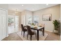 Cozy dining room with natural light, table set for four, and neutral decor at 2813 Punta Palma Ct, Holiday, FL 34691