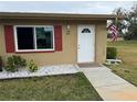 Condo exterior featuring a white door and red shutters at 302 Canton Ct # 63, Sun City Center, FL 33573