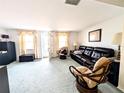 Spacious living room with a leather couch and comfortable seating at 3556 Bradford Dr, Holiday, FL 34691