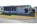 Well-maintained single story home featuring a screened in porch and mature landscaping at 37642 Amigo Dr, Zephyrhills, FL 33541