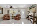 Spacious living room with leather seating, large windows, and tile floors at 3906 Bloomingdale Ave, Valrico, FL 33596