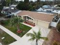 Aerial view of a renovated house with a new roof and landscaping at 5611 Riddle Rd, Holiday, FL 34690