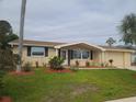 Newly remodeled ranch house with attractive landscaping at 5611 Riddle Rd, Holiday, FL 34690