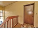 Exterior entryway to condo unit with brown door at 603 N Keene Rd # P12, Clearwater, FL 33755