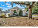 House exterior with tree and driveway, showcasing curb appeal at 7503 Wakulla Dr, Temple Terrace, FL 33637