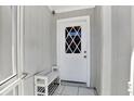 White door with diamond-shaped window and small bench at 7503 Wakulla Dr, Temple Terrace, FL 33637