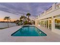 Inviting swimming pool and spa with waterfront view at sunset at 7810 10Th S Ave, St Petersburg, FL 33707