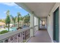 Condo hallway overlooking pool and palm trees at 801 83Rd N Ave # 217, St Petersburg, FL 33702