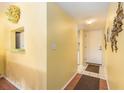 Inviting hallway with warm yellow walls, decorative art, and tile flooring at the entrance at 801 83Rd N Ave # 217, St Petersburg, FL 33702