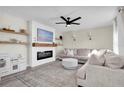 Living room with a modern fireplace, L-shaped sofa, and built-in shelving at 8416 121St Pl, Largo, FL 33773