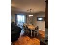 Bright dining room with hardwood floors and table for six at 1314 Riserva Ln, Palm Harbor, FL 34683