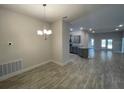 Bright dining area with chandelier and view of kitchen at 13146 Kent Bradley St, Dade City, FL 33525