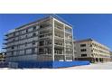 Modern multi-unit building under construction, scaffolding visible, near other structures at 14046 Gulf Blvd # 2, Madeira Beach, FL 33708