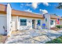 Condo exterior with a patio and blue chairs at 1505 Mission Hills Blvd # 4D, Clearwater, FL 33759