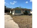 Ranch-style home with green shutters and a large yard at 1819 Grand Blvd, Holiday, FL 34690