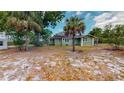 View of home's back and expansive grassy backyard at 2418 2Nd S Ave, St Petersburg, FL 33712