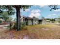 House's side view, showing backyard with large grassy area at 2418 2Nd S Ave, St Petersburg, FL 33712