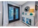 Bright entry with stylish console table and double doors at 2973 Somersworth Dr, Clearwater, FL 33761