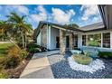 Inviting entryway with a water feature and walkway at 2973 Somersworth Dr, Clearwater, FL 33761