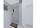 Front entrance with gray door and welcome mat at 3405 W Swann Ave # 6, Tampa, FL 33609