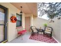 Relaxing front patio with seating area and fall decor at 38351 Ironwood Pl, Zephyrhills, FL 33542