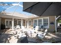 Relaxing patio with seating area, fire pit, and covered lanai at 404 Manns Harbor Dr, Apollo Beach, FL 33572