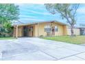 Ranch style home with a large driveway and carport at 4513 W Clifton St, Tampa, FL 33614