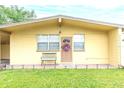 House exterior featuring a brown door and a bench at 4513 W Clifton St, Tampa, FL 33614