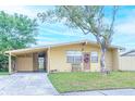 Yellow house with carport and landscaping at 4513 W Clifton St, Tampa, FL 33614