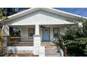 Renovated home with a covered front porch and light blue front door at 502 E Cluster Ave, Tampa, FL 33604