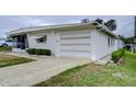 Side view of a manufactured home with carport at 6125 Alpine Dr, Zephyrhills, FL 33542