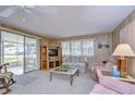 Living room with wood paneling, couches, and a TV at 6125 Alpine Dr, Zephyrhills, FL 33542