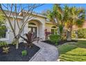 Attractive landscaping surrounds the walkway to the front entrance at 714 Hidden Lake Dr, Tarpon Springs, FL 34689