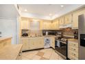 Eat-in kitchen featuring stainless steel appliances, tile backsplash, and lots of cabinet storage at 801 83Rd N Ave # 215, St Petersburg, FL 33702