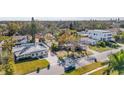 This aerial shows a well-situated home with a manicured front lawn near neighborhood amenities and streets at 90 Huron Ave, Tampa, FL 33606