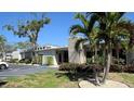 Exterior of Bay Pines Condo Recreation Center with lush landscaping, mature trees, and ample parking at 9940 47Th N Ave # 102-C, St Petersburg, FL 33708