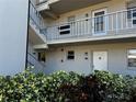 Exterior of a condominium building showcasing walkways, landscaping, and unit entrances at 9940 47Th N Ave # 102-C, St Petersburg, FL 33708