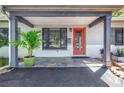 Inviting front entrance with colorful door and tiled porch at 1201 77Th N St, St Petersburg, FL 33710