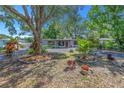 Charming single-story home with mature trees and beautifully landscaped front yard at 1201 77Th N St, St Petersburg, FL 33710