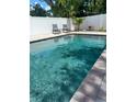 Sparkling private swimming pool surrounded by a white fence at 1201 77Th N St, St Petersburg, FL 33710