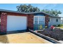 Close up of a well-maintained home with a brick facade and a freshly sealed driveway at 12361 114Th St, Largo, FL 33778