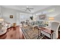 Bright living room with hardwood floors, comfortable furniture, and a view to the kitchen at 1252 Lyndhurst Greens Dr, Sun City Center, FL 33573