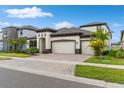 Beautiful single Gathering home with three-car garage and manicured lawn at 13182 Twin Bridges Dr, Riverview, FL 33579