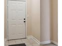 Simple entryway with tiled floors and a white door at 18327 Bridle Club Dr # 18327, Tampa, FL 33647