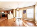 Bright dining room with hardwood floors and glass table at 18840 Parapet Pl, Land O Lakes, FL 34638