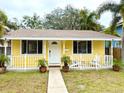 Yellow house with white trim and porch at 2526 44Th S St, St Petersburg, FL 33711