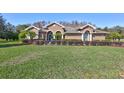 Beautiful home with a manicured lawn and lush landscaping at 2659 Keystone Springs Rd, Tarpon Springs, FL 34688